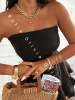 krótki czarny kombinezon muślinowy z gorsetową górą i spódnico-spodenkami z falbankami
